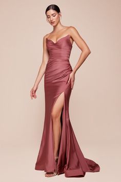 The Ava Gown showcases a strapless pointed V-neckline, a gathered waist, and a stylish leg slit, creating an elegant silhouette. Crafted from stretch spandex satin, it ensures a flawless fit with a lace-up corset back closure. Perfect for bridesmaids, wedding guests, and formal occasions, this dress radiates sophistication. -Silhouette: Fitted -Design: Strapless pointed V-neckline, gathered waistline, leg slit -Fabric & Material: Stretch spandex satin -Fit Detail: Fitted with lace-up corset back Fitted Gowns, Fitted Sheath Dress, Colorful Dresses Formal, Cinderella Divine, Satin Evening Dresses, Corset Back, Evening Dresses Cocktail, Usa Dresses, Gown Prom