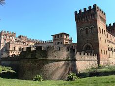 an old castle sitting on top of a lush green field