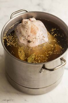 a large metal pot filled with food on top of a table