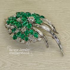 Stunning burst of vivid green emeralds and sparkly white diamonds covering all the surfaces of this beautiful platinum vintage brooch! Total Weight: 29.15 grams Size: 2.5 inch tall, 1.5 inch wide Precious Metal: Platinum Precious stones: -Emeralds: QTY: 31, 2.7mmx4.7mm to 4.2mmx6.3mm size, 7.5 carats -Diamonds: 29 rounds, 20 baguettes, 6 carats Luxury Green Brooch For Anniversary, Green Fine Jewelry Brooches For Wedding, Fine Jewelry Green Brooch For Anniversary, Fine Jewelry Green Brooches For Anniversary, Luxury Green Brooches For Anniversary, Green Diamond Wedding Brooches, Green Fine Jewelry Brooch For Anniversary, Emerald Diamond Brooch, Vintage Platinum Brooch