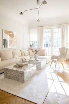 a living room filled with furniture and white walls