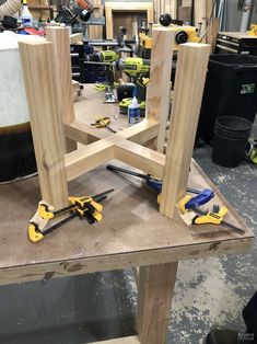 some tools are sitting on a table in a room filled with woodworking supplies and other items