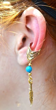 Style Tips: Wear an Ear Cuff with Charm on each ear to get a unique balanced set. Details: Weight: 2.4 grams Metal: Gold overlay on Brass Base Diameter: 0.5" Width: 0.5" Length: 2.0" Color: Gold Adjustable Metal Hypoallergenic Ear Cuff, Adjustable Hypoallergenic Metal Ear Cuff, Blue Metal Clip-on Jewelry, Adjustable Brass Single Ear Cuff, Adjustable Internally Threaded Earrings For Festival, Adjustable Gold Clip-on Jewelry, Adjustable Metal Pierced Body Jewelry, Adjustable Dangle Ear Cuff, Pierced, Adjustable Dangle Pierced Ear Cuff