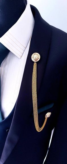 Looking for an elegant and distinctive accessory to elevate your style? Add charm and sophistication to your look with our Elegant Lion Lapel Pin Badge with Gold Chains! It is a masterpiece that'll have you strutting like royalty. It is a fantastic way to give the finishing touch to your outfit. Its striking design and gold chains naturally match your style, making it a remarkable item. Its versatile elegance makes it a timeless treasure for anyone who wants to add a touch of sophisticated swagg Lapel Chain, Indian Wedding Clothes For Men, Lapel Pins Suit, Shirt Collar Pins, Mens Wedding Attire, Formal Clothing, High Fashion Men, Tan Suit, Lapel Pins Mens