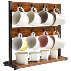 coffee cups and mugs are hanging on a rack