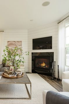 the living room is clean and ready for us to use it's fireplace as a focal point