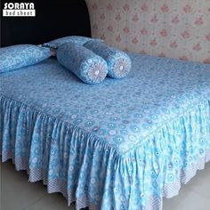 a bed with blue bedspread and pillows on it