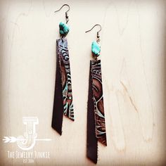 Genuine Leather Rectangle Earring is the perfect complement to your boho or western style. Accented with a turquoise drop accent. Length: 4" Width: .5" Although your item will resemble the photo, each piece is created by hand, so no two are identical.Thank you for visiting The Jewelry Junkie! Diy Turquoise Earrings, Western Style Leather Jewelry Gift, Handmade Rustic Leather Earrings, Handmade Leather Turquoise Earrings, Boho Western Leather Earrings, Boho Earrings Diy, Western Style Hand-tooled Leather Jewelry, Boho Leather Jewelry, Leather Jewelry Making