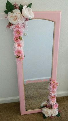 a pink mirror sitting on top of a carpeted floor