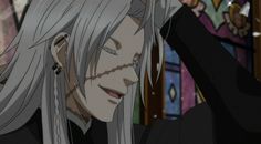 an anime character with long white hair and grey hair, wearing black clothes in front of stained glass windows