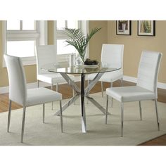 a glass table with white chairs around it