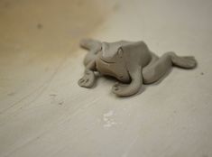 a clay animal laying on top of a table