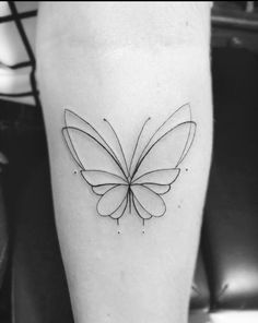 a black and white photo of a butterfly tattoo on the left leg, with lines running through it