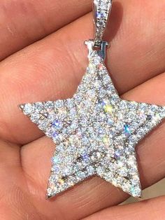 "Custom made super iced out STAR PENDANT. Made from 100% Solid 925 Sterling silver and finished in your choice of either Rhodium or 14k yellow gold. Adorned with 200 micro paved simulated diamonds (CZ) to give this piece an amazing super icy look! Measures approximately 1.25\" x 1.25\" and weighs approximately 8 grams. You can buy pendant only or with choice of 18-30\" 2.5mm diamond cut ball moon chains IF YOU WANT PENDANT ONLY, SELECT \"0\" Chains are also solid sterling silver and come with a Dazzling Star-shaped Cubic Zirconia Jewelry, Celestial Star-shaped Silver Jewelry, Silver Round Pendant With Star Charm, Silver Jewelry With Star Charm On Round Pendant, Silver Round Pendant Jewelry With Star Charm, Silver Round Pendant With Star Charm Jewelry, White Star-shaped Cubic Zirconia Jewelry, Silver Jewelry With Star Charm For Anniversary, Silver Star Charm Jewelry For Anniversary