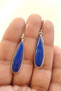 Natural Lapis Lazuli Teardrop Shape 925 Sterling Silver Handmade Earrings PRODUCT DETAILS:- Material: 925 Sterling Silver Length: 4.6 Cm/ 1.8 Inch (Drop Length) Width: 1 CM/ 0.39 Inch Weight: 5.1 Grams (Approximate) GEMSTONE DETAILS:- Stone: Lapis Lazuli Color: Blue Shape: Teardrop Size: 30x8 MM The silver Earring in the photo is the one that you will be purchasing. Genuine sterling silver Earring and Natural Lapis Lazuli Gemstone. This is a simple and elegant piece of Handmade jewelry at a very Blue Gemstone Earrings, Lapis Lazuli Earrings, Drop Dangle Earrings, Earrings Blue, Blue Gemstones, Silver Earring, Online Earrings, Wire Jewelry, Handmade Earrings