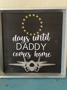 a sign that says, days until daddy comes home on the side of a wall