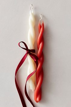 two red and white candles tied together