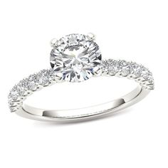 Classic and elegant, this diamond engagement ring will win her heart - and her hand. Expertly crafted in cool 14K white gold, the eye is drawn to the 1/2 ct. round diamond center stone standing tall in a traditional four-prong setting. Smaller round accent diamonds line the ring's slender shank, completing the design. The perfect look for the sophisticated bride, this engagement ring captivates with 1 ct. t.w. of diamonds and a polished shine. Gold Diamond Ring Designs, Gold Flower Ring, Pearl Engagement Ring, Nature Inspired Rings, Elegant Engagement Rings, Diamond Promise Rings, Engagement Ring White Gold, Bridal Engagement Rings, Round Diamond Engagement Rings