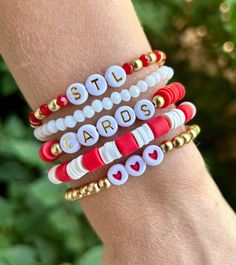 This is a cute stack of 5 bracelets, perfect for any Saint Louis Cardinal Fan!  ❤️The wording can be changed~ example: birds, a player's name, etc.  ❤️This stack can be made in gold or silver.  ❤️All gold beads are 14k gold filled, anti-tarnish beads.  ❤️{Personalization} Please let me know if you would like any wording changed, and if you would like the bracelets made with gold or silver beads. ❤️{Sizing}  These come in any size~ adult or kids. To find your perfect size, please see the measurement instructions in the item images. The average adult size is 7.  Please feel free to message me with any questions. Thank you! Softball Beaded Bracelet, Red Stacked Beaded Bracelets For Gifts, Red Stacked Beaded Bracelets As Gift, Adjustable Red Stackable Beaded Bracelets, Everyday Red Stretch Bracelet With Round Beads, Red Adjustable Stackable Beaded Bracelets, Adjustable Stackable Red Beaded Bracelets, Personalized Red Friendship Bracelets, Red Personalized Friendship Bracelets