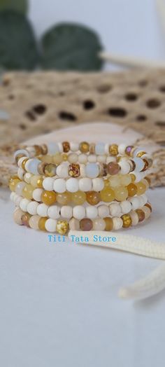 TitiTataStore.com Always FREE SHIPPING and a FREE GIFT! I Will Ship Within 24 Hours! Description: This listing is for a Set of 5 Handmade Beach Bracelets.  Materials: 6mm Wood Beads,  6mm White Frosted Sea Glass beads, 6mm Beige Howlite Beads, 6mm Yellow Aventurine Beads, 6mm Faceted Jade beads, 5mm Coconut Shells, Indian Glass Beads, Howlite  Heishi Beads, Czech Glass Faceted beads, and Faceted Beige Glass Beads. The beads were strung using a high-quality elastic stretch cord for durability.  Size: Each bracelet is suitable for a wrist circumference of about 7". Final Touch: Your bracelet will be nicely packed in a Burlap Gift Bag. ❤ All orders are shipped FREE via USPS First Class Mail with tracking number. Please visit my store for many other colorful bracelets! I can customize any of m Bohemian Stackable Jewelry For The Beach, Bohemian Stackable Beach Jewelry, Bohemian Beach Stackable Jewelry, Spiritual Beaded Bracelets For Summer, Bohemian Bracelets With Round Beads For Vacation, Stackable Beaded Bracelets For Beach, Bohemian Stackable Friendship Bracelets For Summer, Yellow Bracelets With Round Beads For Vacation, Spiritual Stackable Beaded Bracelets For Beach