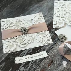 two wedding cards with ribbons on them