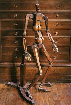 a wooden skeleton standing in front of a dresser