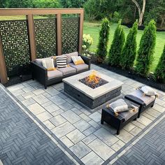 an outdoor patio with seating and fire pit