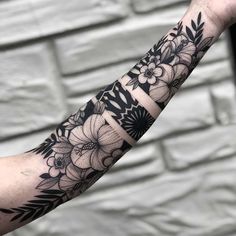 black and white flower tattoo on the arm