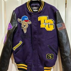 New, No Tags. Top Gun, Gold, Black And Purple Wool Quilt Lined Insulated Jacket. Wool And Polyester. Embroidered Patches On Front And Back. Men’s Small. Measures 21 Inches Pit To Pit And 28 Inches Shoulder To Hem. Inside And Outside Pockets. Extra Buttons. Snap And Zip Close. Purple Varsity Jacket For Fall Streetwear, Purple Patchwork Outerwear For Streetwear, Purple Varsity Outerwear For College, Purple Varsity Jacket For Streetwear, Casual Purple Varsity Jacket For College, Casual Purple Varsity Jacket For Winter, Casual Purple Long Sleeve Varsity Jacket, Casual Purple Outerwear For College, Winter College Purple Outerwear