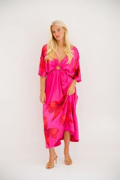 Be the queen of style with our Wrap Queen Pink Dress! Featuring playful red bows, a circle cutout design, and a deep v-neck, this short-sleeved maxi dress is perfect for any occasion. Its loose fitting silhouette adds comfort and flair to your wardrobe. Stand out in this quirky and fun number! All orders are currently shipping within 14 business days. To receive item quicker, expedited shipping is available at checkout. **All Christmas orders must be placed with expedited shipping to guarantee d