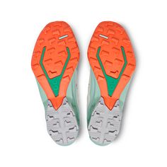 an orange and green sneaker is shown from the top down on a white background