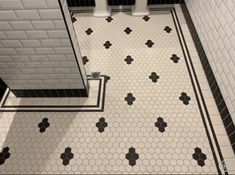 a bathroom with black and white tile flooring