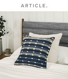 a bed with pillows on top of it and the words article written in front of it