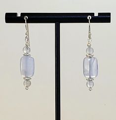 - Stunning Blue Chalcedony Beaded Gemstone Earrings with 925 Sterling Silver Filled accents and 925 Sterling Silver Bali Hook Ear Wires with longer Tails. - Center 4x8mm highly Polished Puff Rectangle Beads with 2 Round 4mm Matching Beads for balance. - Accented by 925 Sterling Silver Plated Bright Twist Heishi Beads and 925 Sterling Silver tiny Round Beads. - 925 Sterling Silver Bali Hook Ear Wires with tiny Ball Ends and 25mm Length longer "Tails" for security. See Photos #1-2. If you want sho Elegant Adjustable Beaded Earrings With Gemstone Beads, Elegant Earrings With Gemstone Beads, Adjustable Drop Earrings With Gemstone Beads, Chalcedony Dangle Earrings With Matching Jewelry, Chalcedony Dangle Jewelry With Matching Earrings, Silver Earrings With Gemstone Round Beads, Silver Earrings With Gemstone Beads, Silver Beaded Drop Earrings With Natural Stones, Silver Dangle Earrings With Gemstone Beads