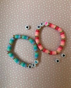 two bracelets with beads and letters on them