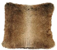 a brown and black fur pillow on a white background