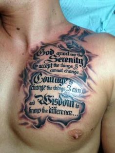 a chest tattoo with some words on it