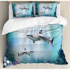 two sharks swimming in the ocean with corals and seaweed on the bedding