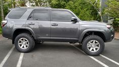 a gray toyota 4runner is parked in a parking lot