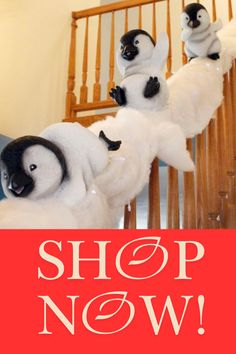 two stuffed penguins sitting on top of each other with the words shop now above them