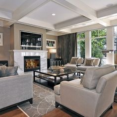 a living room filled with furniture and a fire place in the middle of a room