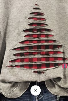 a person wearing a shirt with a christmas tree on it