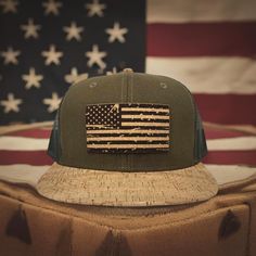 Elevate your outdoor style with the 'Merica Distressed Flag Flat or Curved Bill Snapback by KORKIT Company featuring a precision-engraved cork patch, breathable lightweight mesh, Cork Bill, and 6 Panel Construction. Crown: 60% Cotton / 20% Linen / 20% Polyester Visor: 100% Cork & Polyurethane 6 Panel Structured 8 Rows Stitching on Visor Plastic Snap Closure  OSFM - Adult (6 1/2 - 7 5/8) Crown Height - Mid Profile: 8.6 cm / 3.4" Outdoor Style, Trucker Cap, Caps Hats, Cork, Accessories Hats, Flag, Display Homes, Paper Party Supplies, Craft Supplies