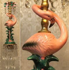 a pink flamingo lamp sitting on top of a table next to a chandelier