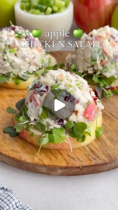 an apple chicken salad on a wooden cutting board