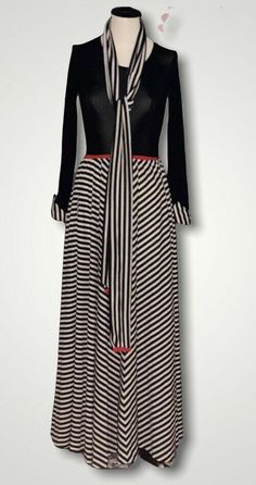 Vintage 1970’s Vera Maxwell Speed Suit Maxi Dress. He Dress has a black stretch bodice that was designed to slip over your head with a red detail around the waist. The skirt of the dress is black and white striped with side pockets and with matching detail on the cuffs of the sleeves. The dress also has the original matching scarf, which is a rare find. The dress is a vintage size LARGE. Shown on model with bust- 34” waist-26” sleeve length -23” overall length-58” Fabric is Jersey/Polyester (Lot Elegant Maxi Dress With Vertical Stripes, Retro V-neck Lined Maxi Dress, Vintage Long Sleeve Striped Dresses, 1970s Style Maxi Length Lined Dress, Black And White Striped Maxi Dress, Vintage Maxi Dress, Black Stretch, Black Stripes, White Stripe