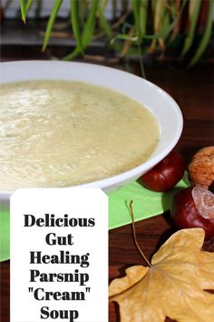 a white bowl filled with soup next to autumn leaves