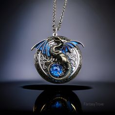 This stoic dragon has taken an oath to guard your most precious memories within this highly-detailed fantasy dragon locket necklace. The wings are hand-painted with a color shift effect that changes from blue to red-violet. There is a 11mm synthetic glass blue opal which nestles within its tail. The inside of the locket is large enough to fit herbs, medication, small notes, pictures and more! Choose from a silver, bronze or gunmetal toned chain up to 30" in length. I also have oxidized sterling