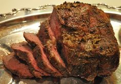 a large piece of meat sitting on top of a metal plate