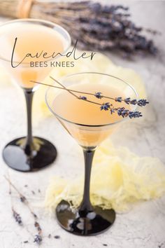 two glasses filled with lavender bee knees on top of a table